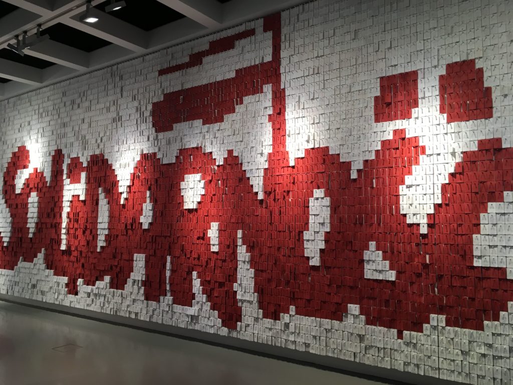 A wall of post it notes from thousands of visitors spelling out the word 'Solidarity'