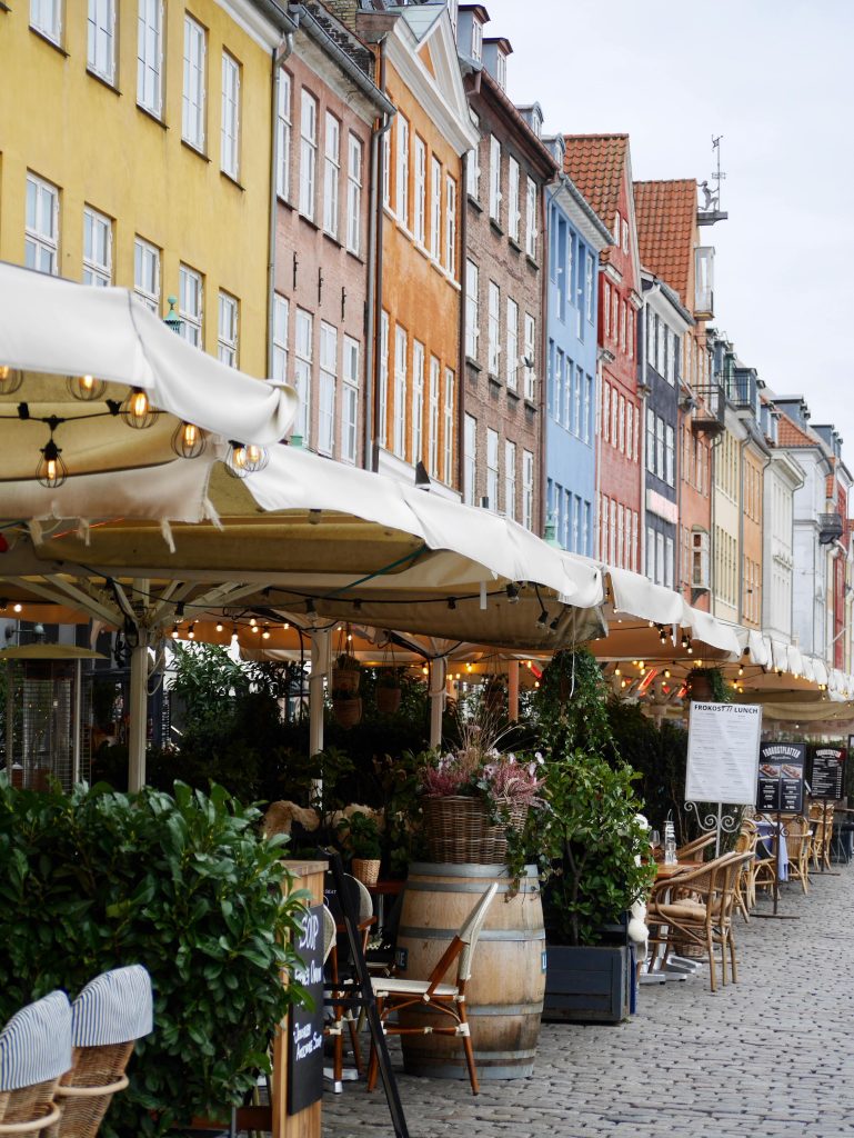 Shows some of the outside restaurants in Nyhavn, illustrating the easy access to the outside spaces.