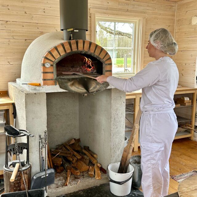 Baking the flatbread in the baking cabin at Mjälloms tunnbröd