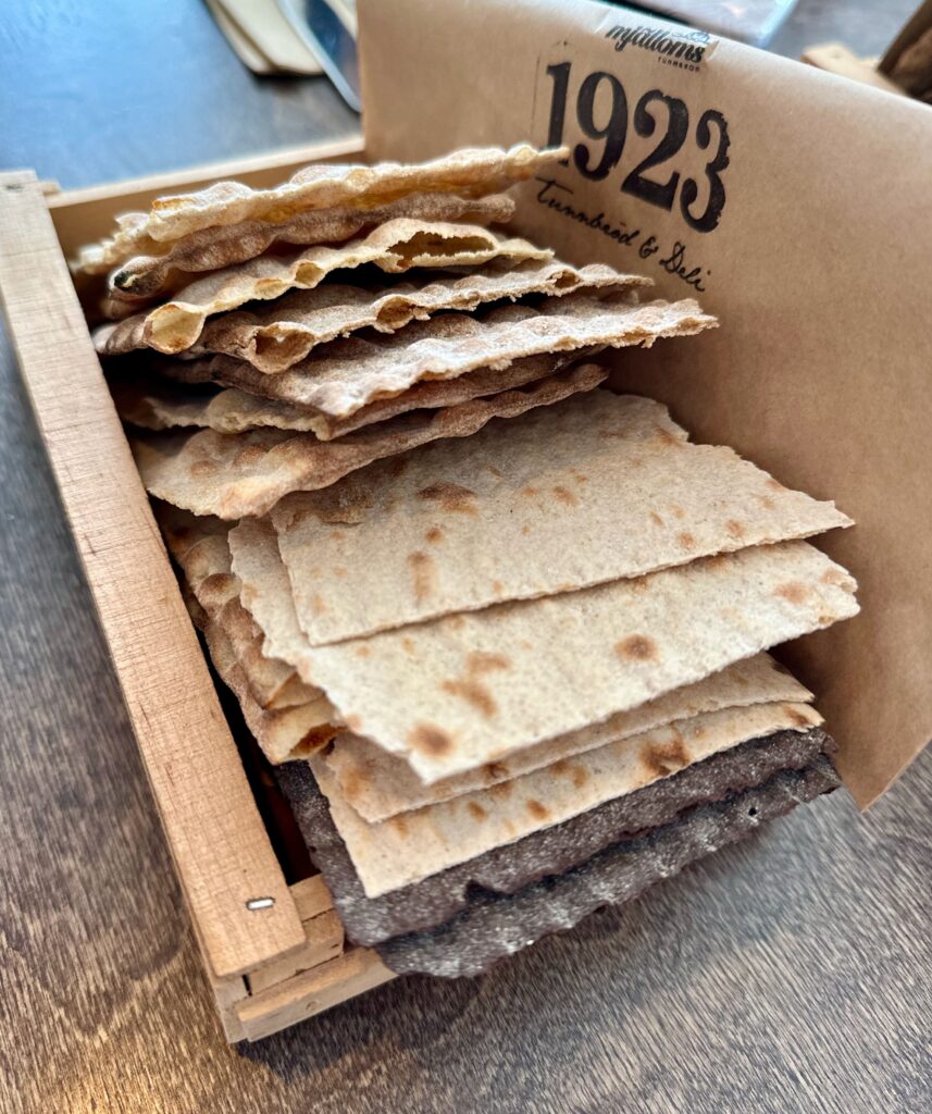 A variety of the flatbreads produced at Mjallöms Tunnbrod along with a  card saying 1923, the year the bakery opened.  Ramps allow entry into the bakery, ensuring it is accessible for all.