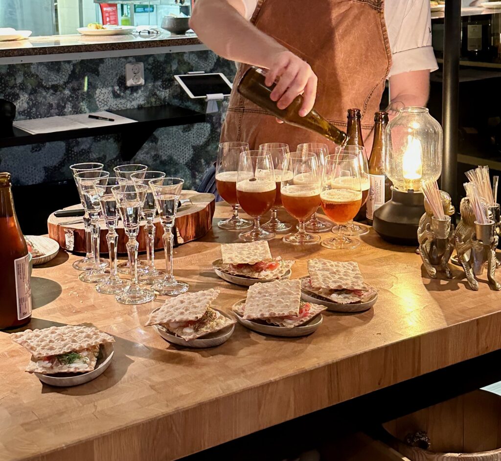 Picture shows freshly prepared Surströmming along with beers ad shot glasses filled with whisky